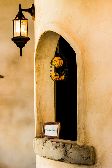 塗り壁とアーチ型ニッチに照明を組み合わせた、雰囲気のある店舗内装デザイン